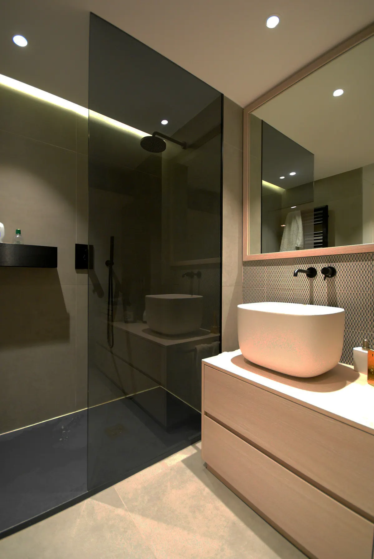 Walk-in shower with greige tile, black glass, and a rain head